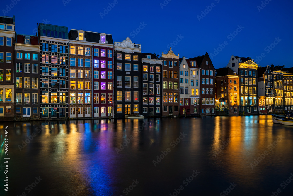 Traditional Dutch housed by the canal in Amsterdam at night, Holland