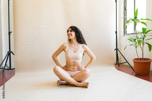 Relaxed woman relaxing in her underwear promoting body positivity