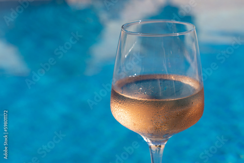 rose wine by the blue water alcoholic drink for summer and celebration