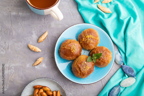 Traditional turkish dessert sekerpare with almonds and honey on gray concrete, top view. photo