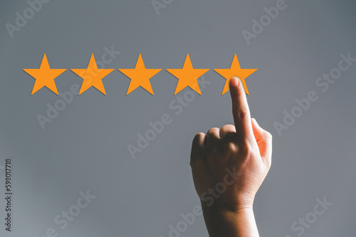 Customer experience with customer service and satisfaction concept. Woman finger touching on five star excellent rating on background, copy space, Customers show satisfaction and quality of services.