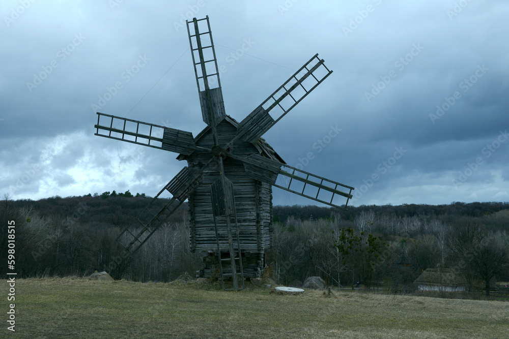 Old wooden windmills working in the evening light. Pyrogove village, Ukraine