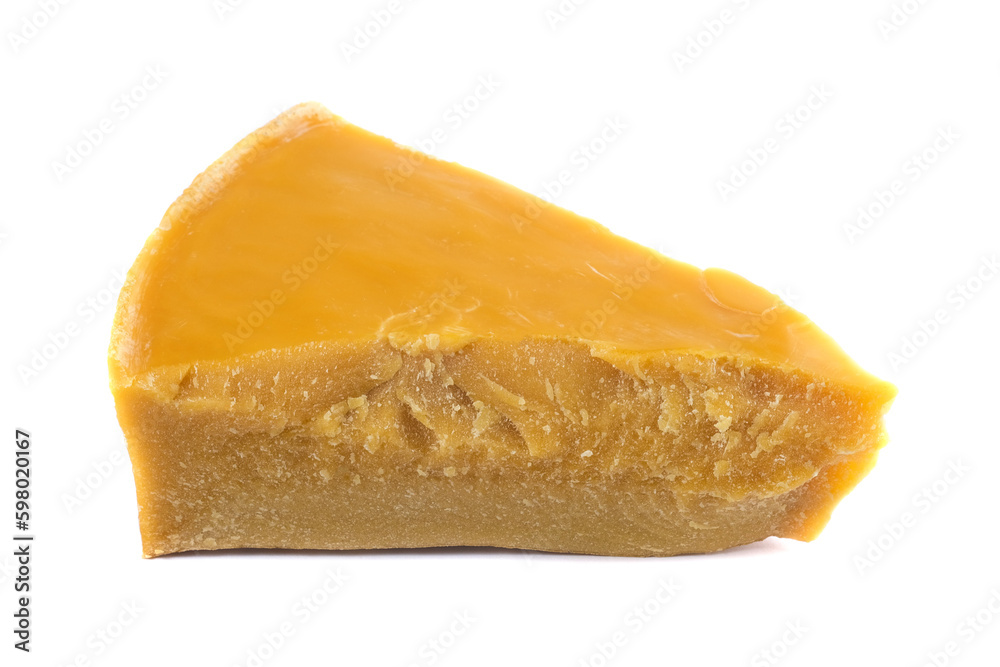 A piece of natural beeswax on a white background.