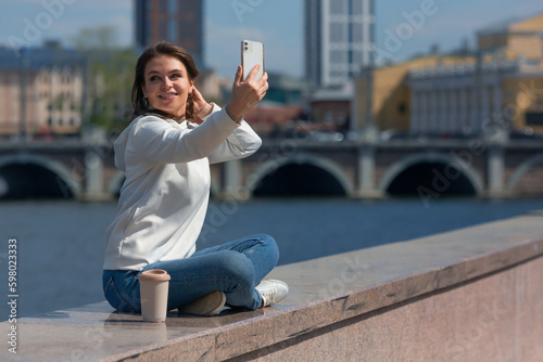 Taking a selfie with smartphone during outdoor walk.