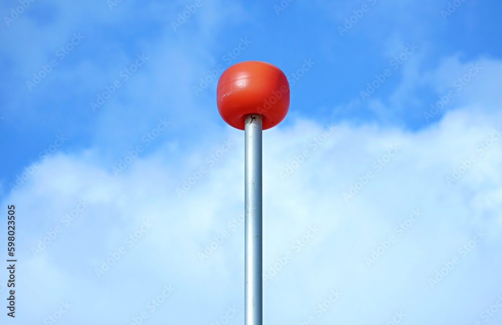 Orange balloon on the mast of the yacht