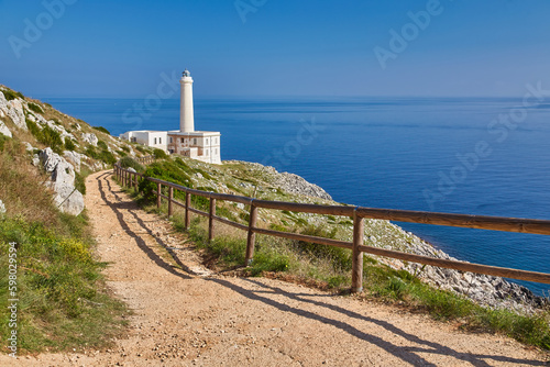 Photos Scenic view of cliff path on the sea Punta Palascia lighthouse on background