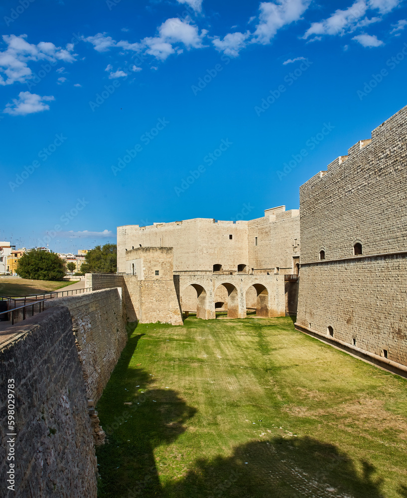 beautiful Romanesque Cathedral Basilica of San Nicola Pellegrino, in Trani. Construction in limestone tuff stone, pink and white. A pointed arch under the bell tower. In Puglia, Bari, Barletta