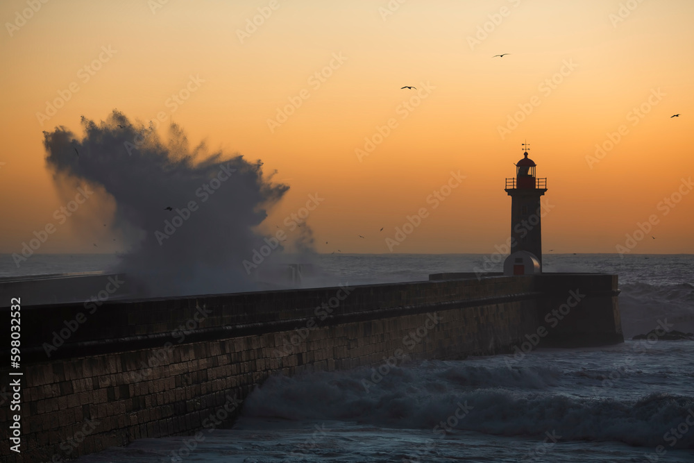 View of the Lighthouse of Cabeca de Molhe during a beautiful sunset, Porto, Portugal.