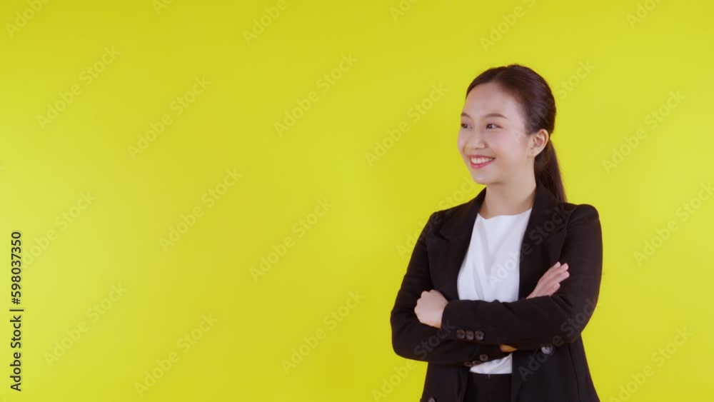 Portrait beautiful businesswoman in suit with arms crossed standing isolated on yellow background, young asian business woman is manager or executive smile with confident is positive and success. Portrait beautiful businesswoman in suit with arms crossed standing isolated on yellow background, young asian business woman is manager or executive smile with confident is positive and success.
