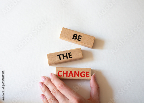 Be the change symbol. Concept word Be the change on wooden blocks. Businessman hand. Beautiful white background. Business and Be the change concept. Copy space