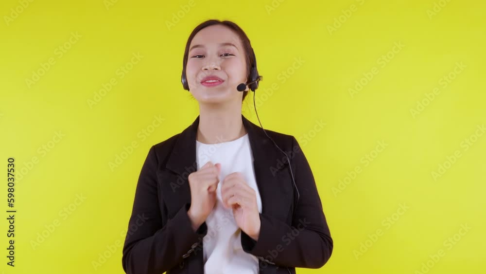Portrait young asian business woman call center wearing headset on yellow background, agent with support and service, businesswoman is assistant for client with phone or helpline online. Portrait young asian business woman call center wearing headset on yellow background, agent with support and service, businesswoman is assistant for client with phone or helpline online.