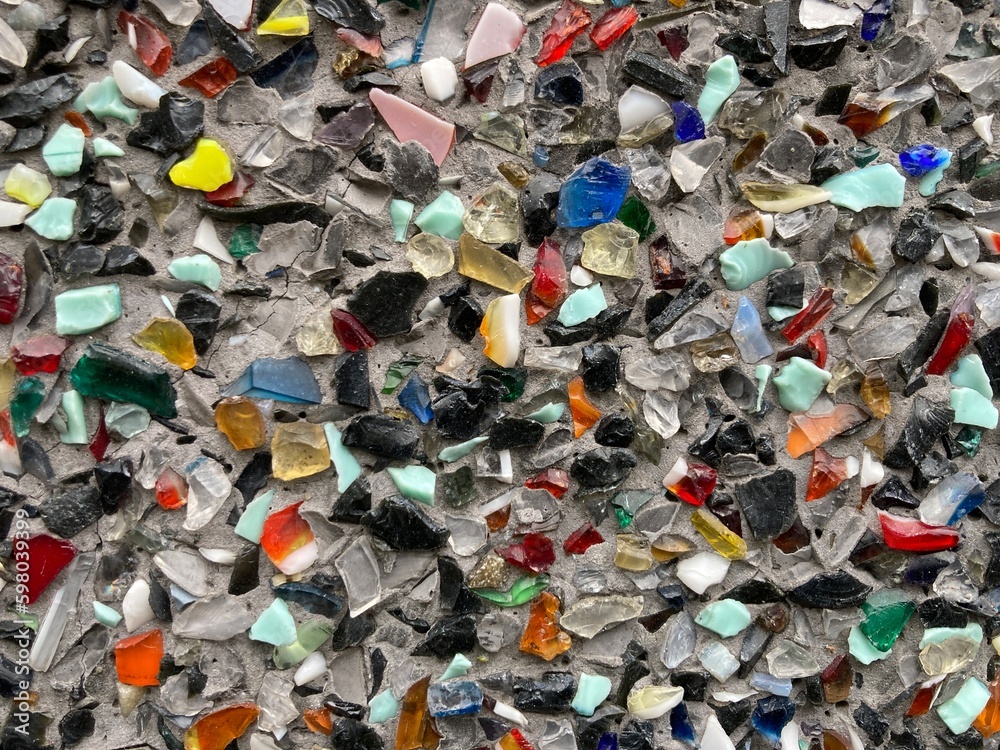 small colorful glass shards on a gray surface