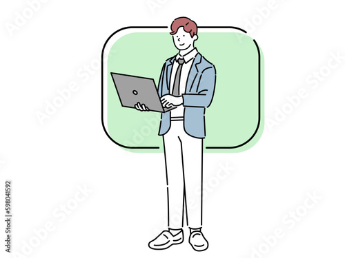 Standing business man working on laptop full body