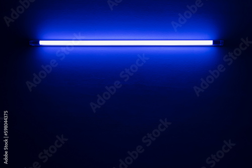 blue neon light bulb on white wall..