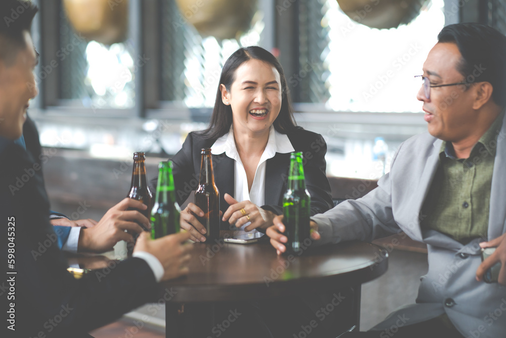 Group Of Asian Friends Enjoying Evening Drinks in bar. Celebration, Party People Christmas and Happy new year concept. Asian business people in party. Group Of Asian Friends Enjoying Evening Drinks in bar. Celebration, Party People Christmas and Happy new year concept. Asian business people in party.