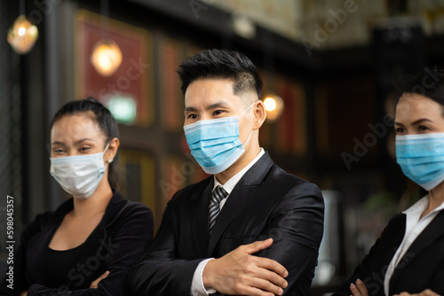 Portrait Of Business Team waring face mask inside modern Office. Group of Asian business people with businessman leader.