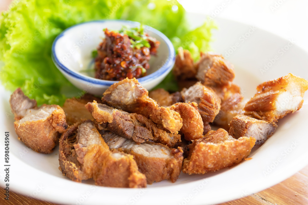 Sliced crispy pork belly with dipping sauce (spicy fermented fish sauce dip). Sliced crispy pork belly with dipping sauce (spicy fermented fish sauce dip).
