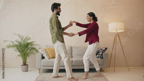 Happy loving couple having fun in kitchen, dancing together Generative AI