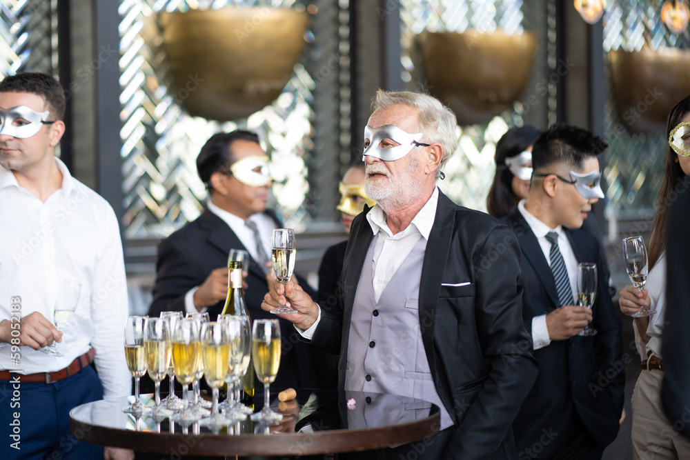 Masquerade party. Beautiful women and men wearing fantasy mask. Company employee enjoy drinking in mask party together indoors celebration Masquerade party. Beautiful women and men wearing fantasy mask. Company employee enjoy drinking in mask party together indoors celebration