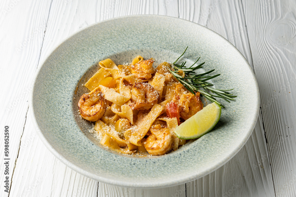 delicious pasta in a plate on a white wooden table. close-up
