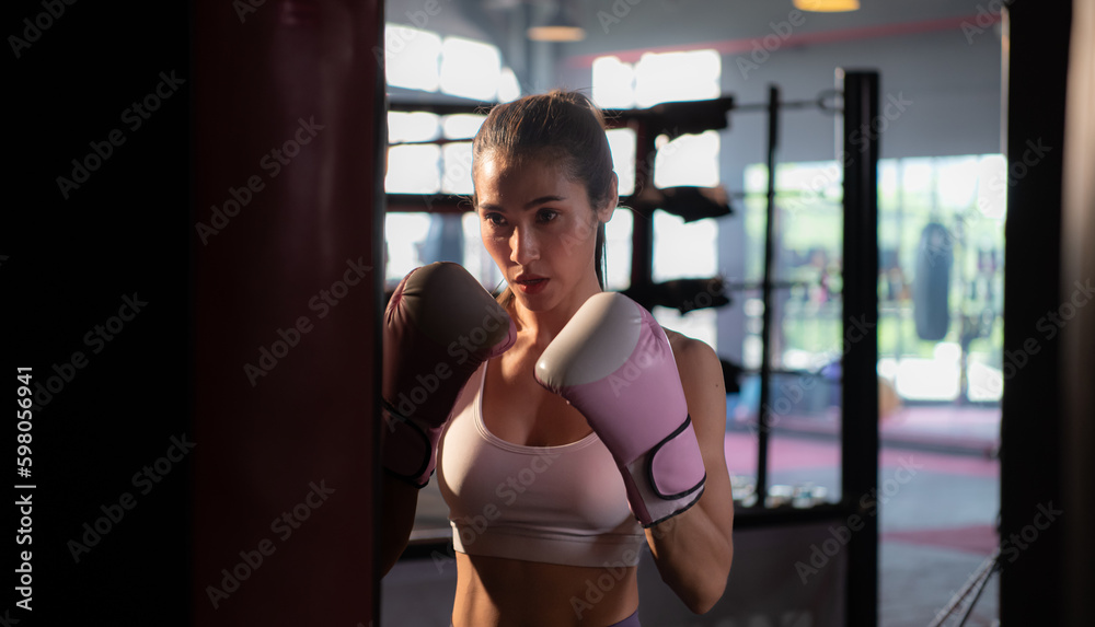 Portrait of woman learning Muay Thai to build up the strength of the body and use it for self-defense.