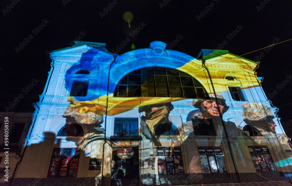 The building of the Ukrainian theater in the center of Odessa, painted in different colors in the Ukrainian style, a light show