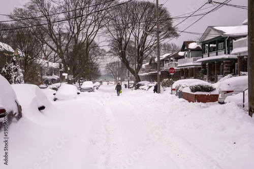 A snow filled residential street being shovelled out after a snow fall. Shot in the Toronto’s Beaches in February. 