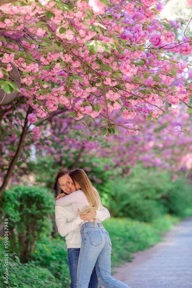 Beautiful young couple, man and woman hugging and having fun in the spring park. Beautiful young couple, man and woman hugging and having fun in the spring park.