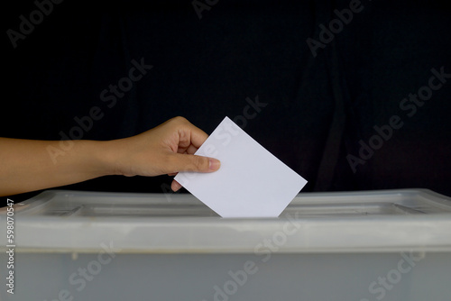 Thai people cast their ballot papers into the box to vote for members of the House of Representatives, using election on a constituency basis and Party-list proportional representation.