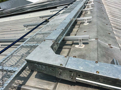Electric cable conduit and walkway on the roof of the solar cell system.