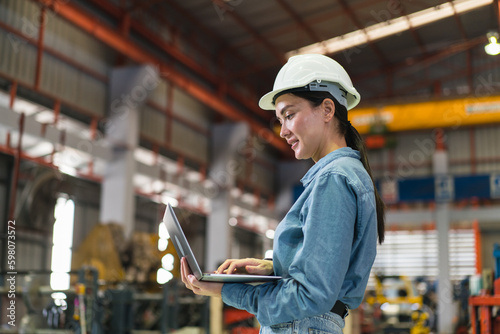 The project manager and engineers are inspecting workpieces and checking standards and safety for products and safety in the factory. Technician and Female Worker Talking on a Meeting in a Factory.