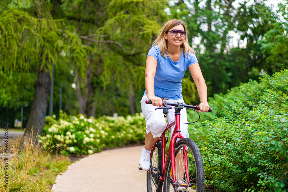 Woman riding bicycle in city park
Woman riding bicycle in city park