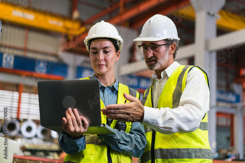 The project manager and engineers are inspecting workpieces and checking standards and safety for products and safety in the factory. Technician and Female Worker Talking on a Meeting in a Factory.