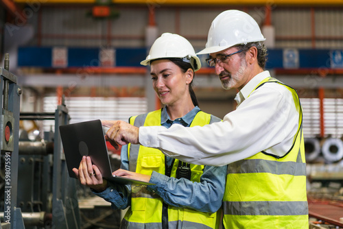 The project manager and engineers are inspecting workpieces and checking standards and safety for products and safety in the factory. Technician and Female Worker Talking on a Meeting in a Factory.