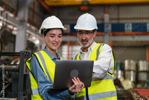 The project manager and engineers are inspecting workpieces and checking standards and safety for products and safety in the factory. Technician and Female Worker Talking on a Meeting in a Factory.