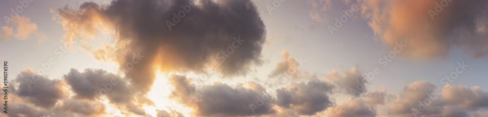 panorama of a sky in warm evening light. massive clouds in orange color at sunset panorama of a sky in warm evening light. massive clouds in orange color at sunset