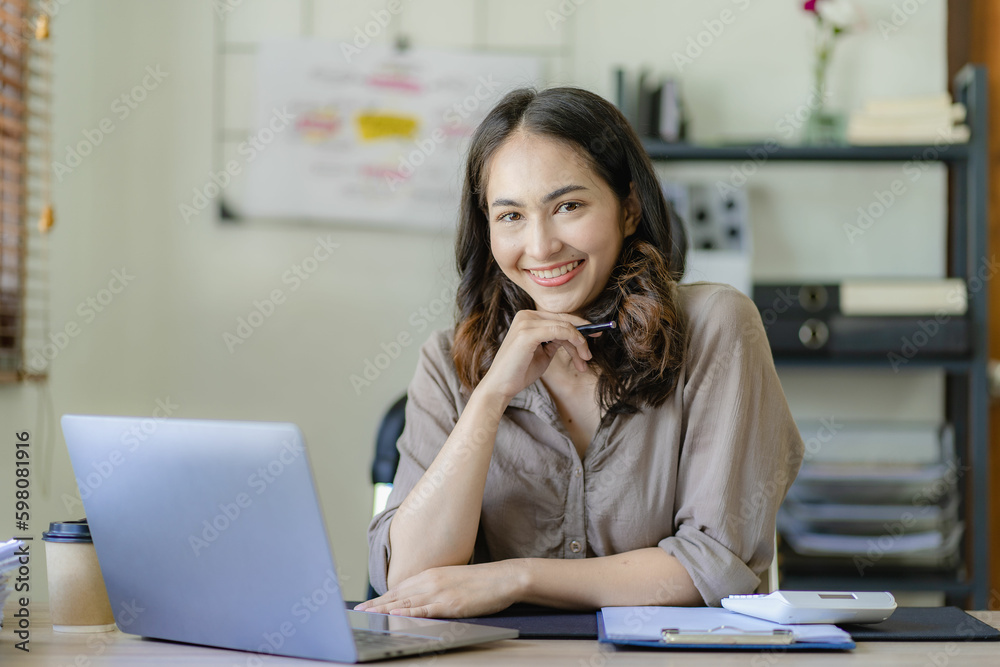 Beautiful Asian businesswoman working from home with tablet computer, small business owner, freelancer online marketing sme ecommerce marketing concept Beautiful Asian businesswoman working from home with tablet computer, small business owner, freelancer online marketing sme ecommerce marketing concept