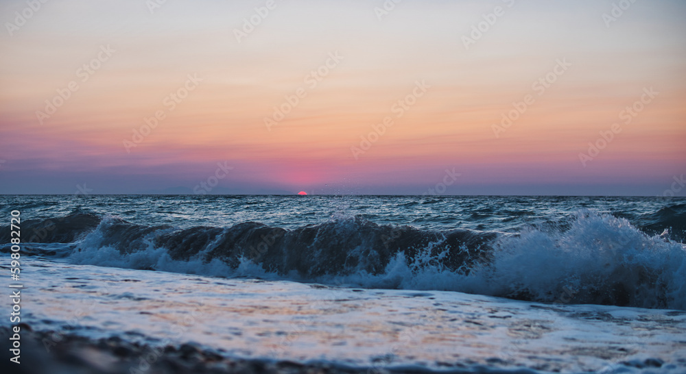 Sunset over Mediterranean Sea seen from a beach at Rhodes island