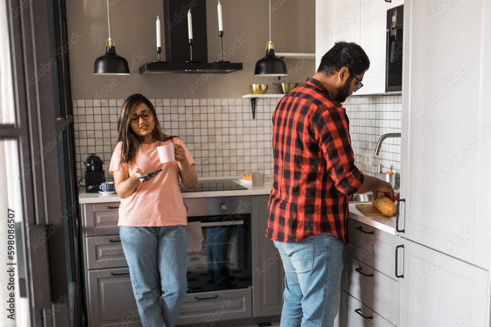 Millennial couple in quarrel and woman with smartphone ignoring each other having breakfast together at home, gadget overuse - communication problem in family Millennial couple in quarrel and woman with smartphone ignoring each other having breakfast together at home, gadget overuse - communication problem in family