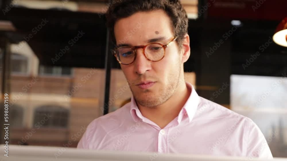 man putting on his glasses and headphones to speak in a meeting man putting on his glasses and headphones to speak in a meeting