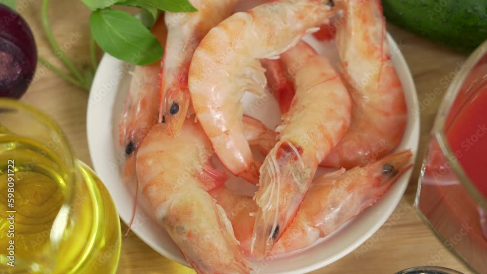 Fresh boiled shrimp in a bowl among other ingredients for the warm shrimp salad Fresh boiled shrimp in a bowl among other ingredients for the warm shrimp salad