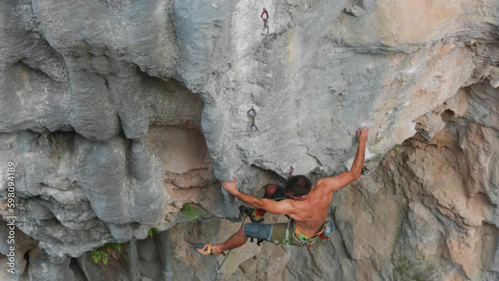 rock climber climbs a rock in slow motion. a strong man overcomes a difficult route. relaxation and freedom in nature. rock climber climbs a rock in slow motion. a strong man overcomes a difficult route. relaxation and freedom in nature.