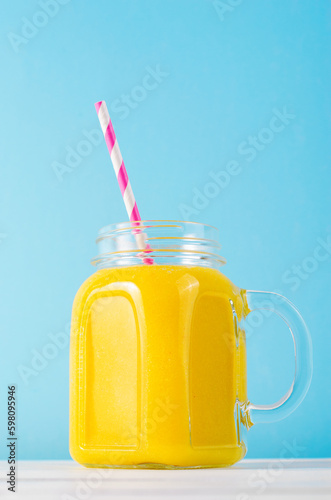 Orange Smoothie in a Jar, Vitamin Drink or Cocktail on Bright Background