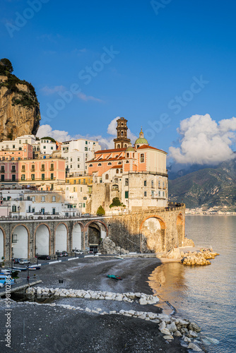 Atrani, Italy. View of the small seaside village of Atrani and its beach, on the Amalfi Coast. In the distance the coast of Salerno. Vertical image. 2022-12-28. © Alessandro