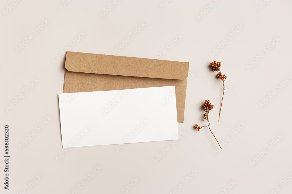 Empty white paper card and craft paper envelopment, autumn letter top view mock up, autumn greeting or invitation card with trend dry plant, minimal botanical style flat lay, fall season - obrazy, fototapety, plakaty 