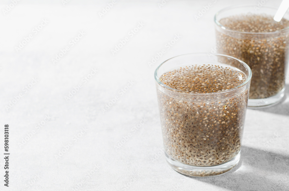 Chia Infused Water with Lemon, Healthy Citrus Drink on Bright Background