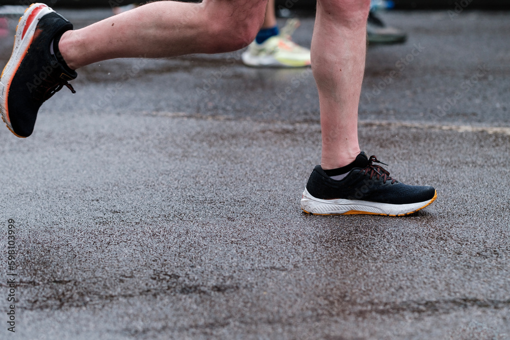 Legs of unrecognizable people running London Marathon.