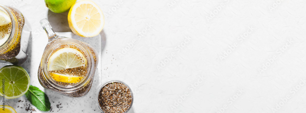 Chia Infused Water with Lemon and Lime in Jars, Healthy Citrus Drink on Bright Background Chia Infused Water with Lemon and Lime in Jars, Healthy Citrus Drink on Bright Background