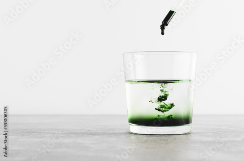 Liquid Chlorophyll in a Glass of Water, Superfood, Healthy Eating, Detox Concept photo