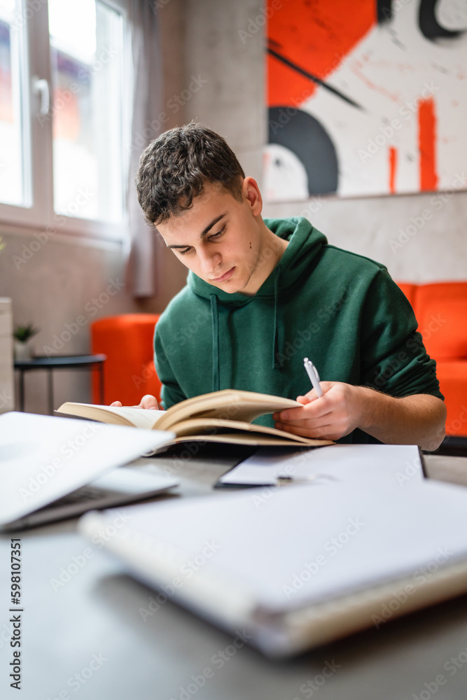 Young man caucasian teenager read book study at home education concept